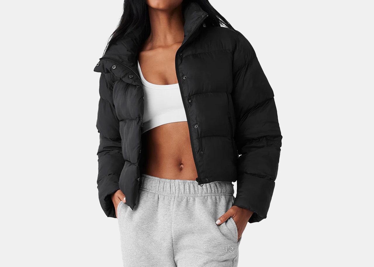 model wearing short, black winter puffer jacket