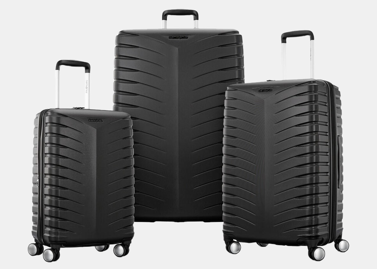 three black rolling suitcases
